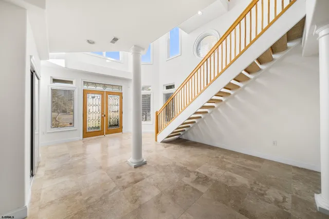 a view of a yard with plants and trees