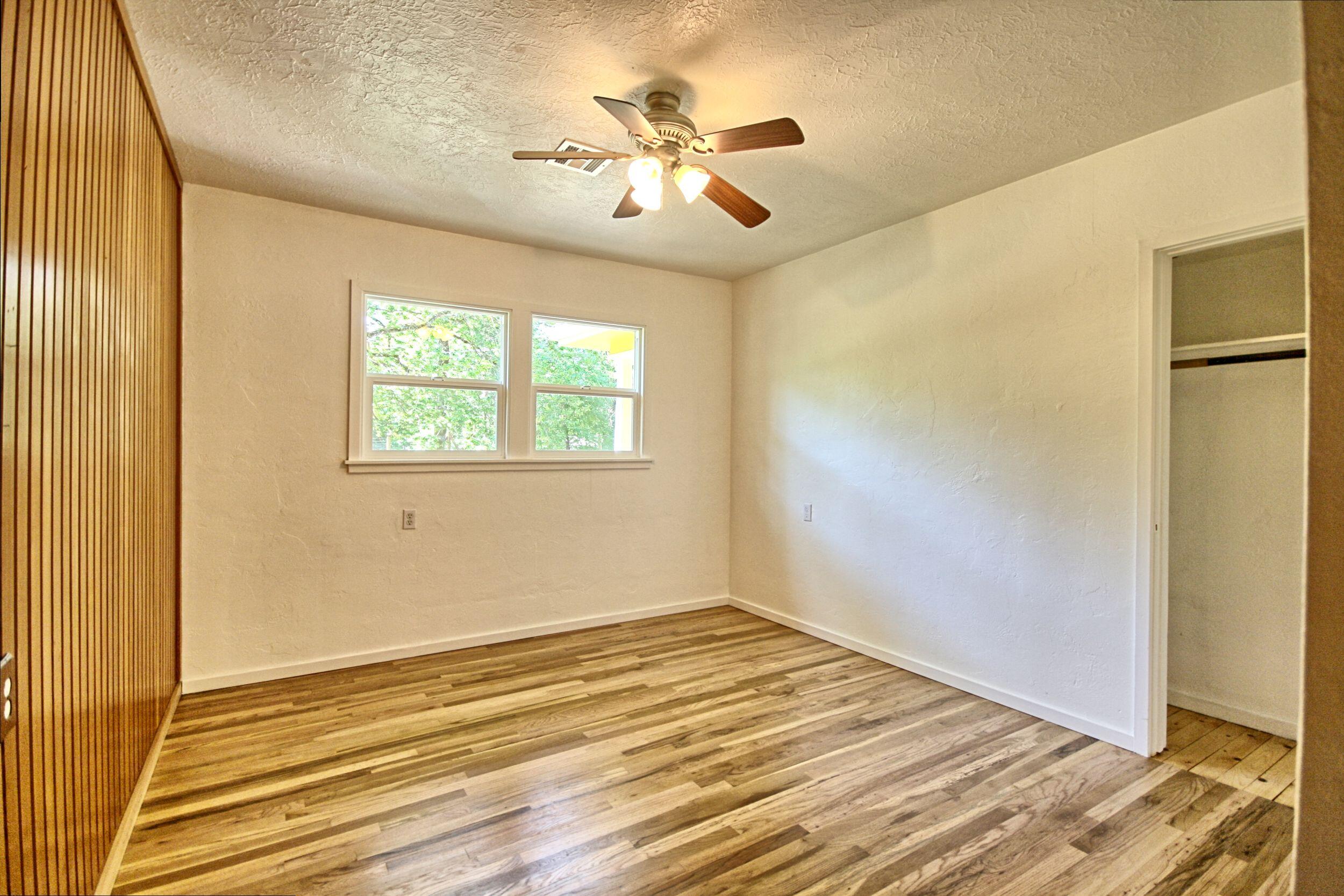 199 Powell Creek Road Williams, OR 97544 - Photo 31 of 57 a view of an empty room with wooden floor and a window