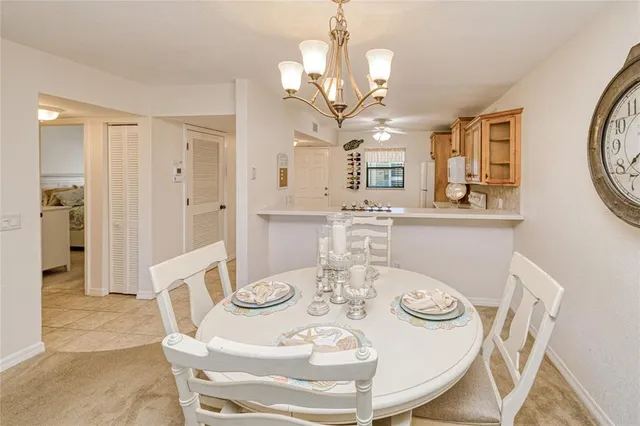 a view of a dining room with furniture a chandelier and wooden floor