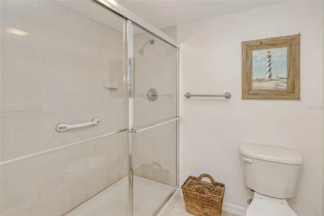 a bathroom with a toilet and a shower