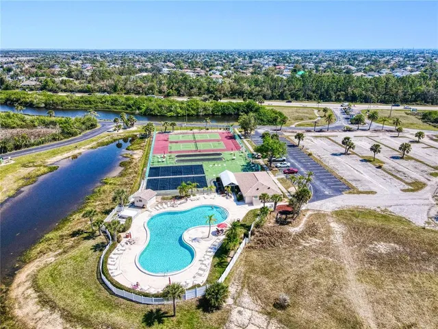 an aerial view of a house with swimming pool outdoor space and seating