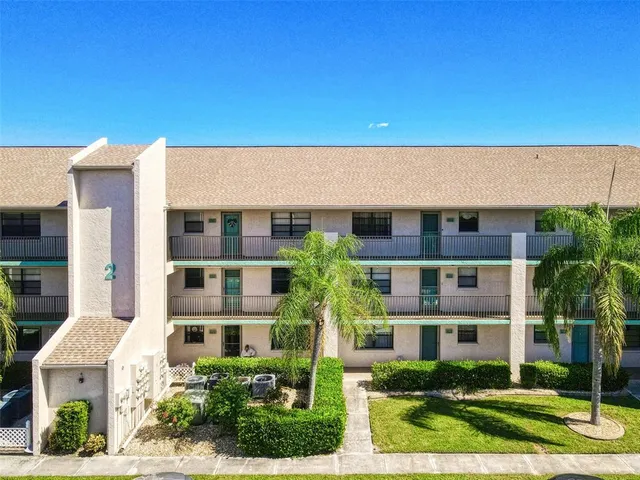 a front view of residential houses with yard