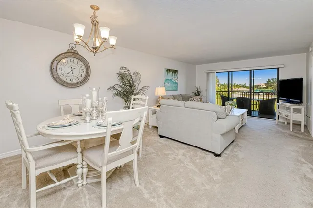 a living room with furniture a dining table and a clock