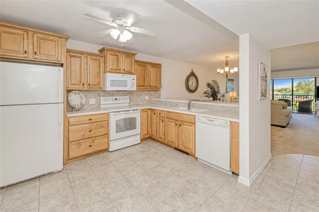 a kitchen with cabinets stainless steel appliances and a window