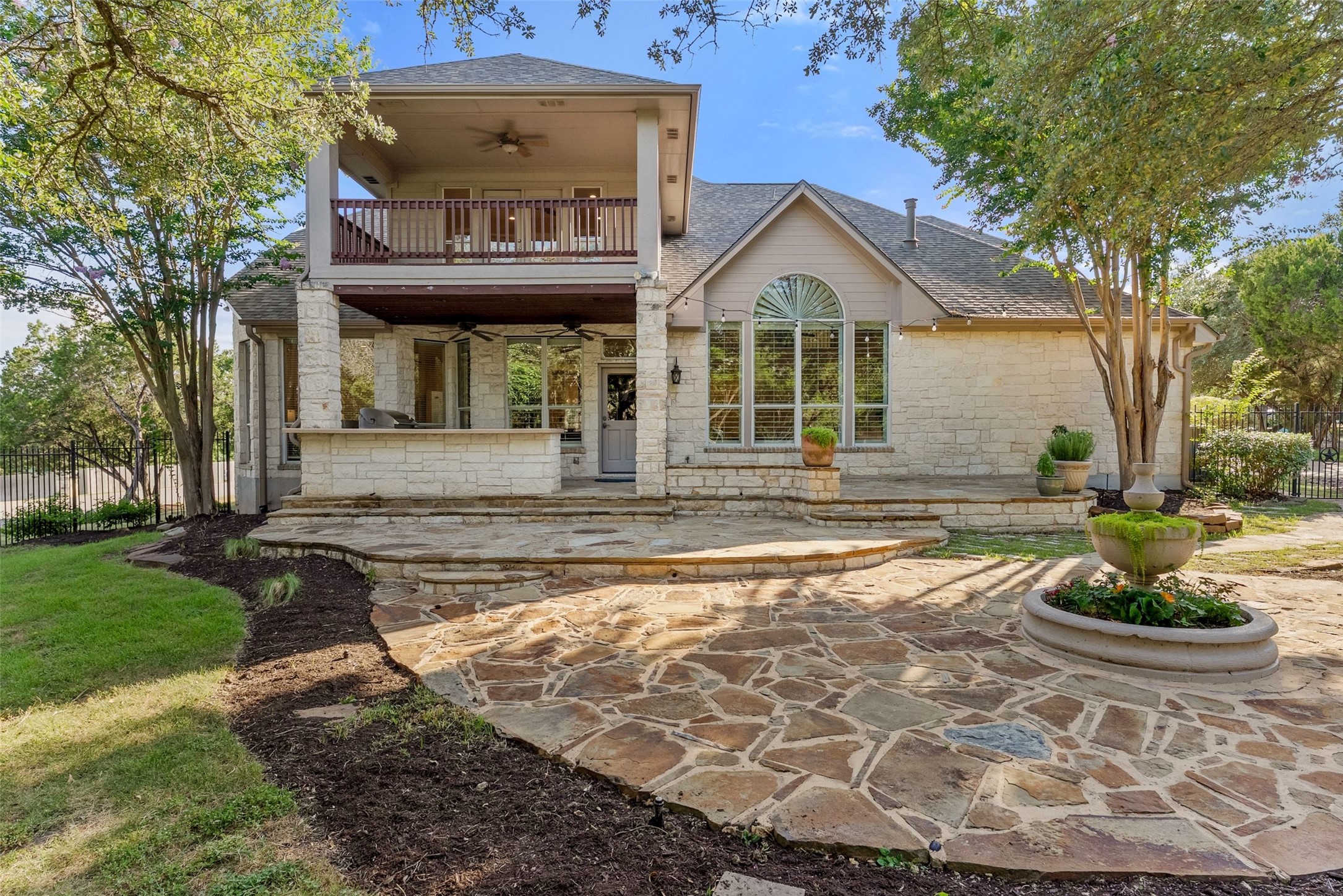 8215 Dark Ridge Cove Austin, TX 78737 - Photo 32 of 40 The backyard features a large stone patio, outdoor kitchen, and lush landscaping with room to expand.