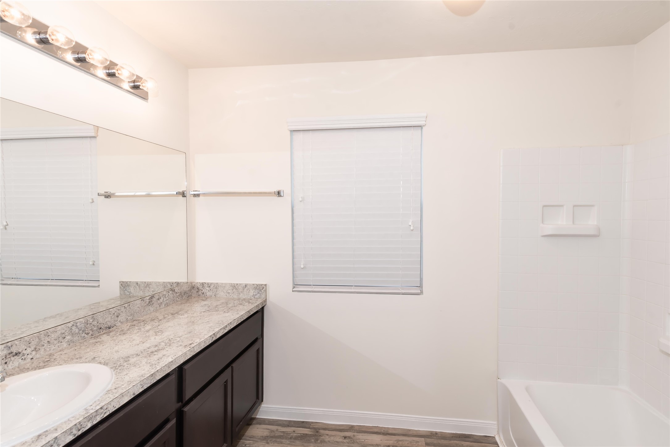 5312 Rio Ramos Street Rosharon, TX 77583 - Photo 9 of 11 a bathroom with a granite countertop sink and vanity
