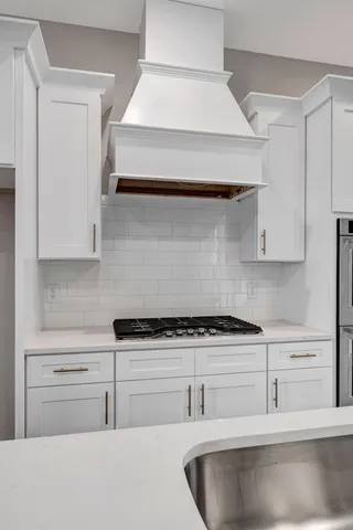 a kitchen with white cabinets and a sink