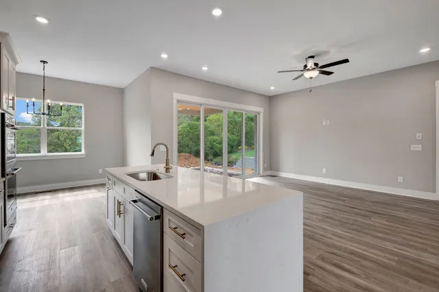 a open kitchen with stainless steel appliances granite countertop a sink stove and refrigerator