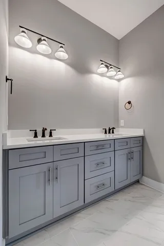 a spacious bathroom with double sink and a mirror