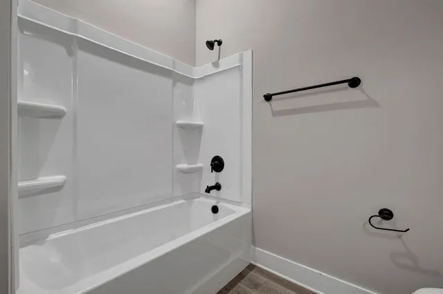 a bathroom with a bathtub and shower