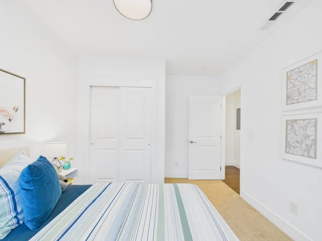 a view of a bedroom with a bed and a couch
