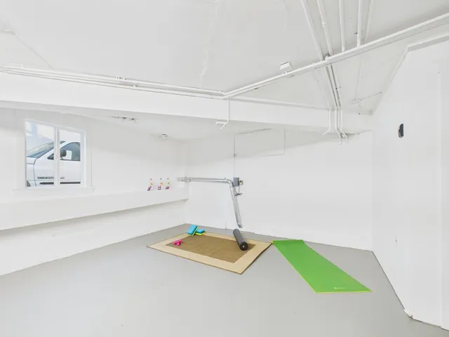 a room with pool table and window