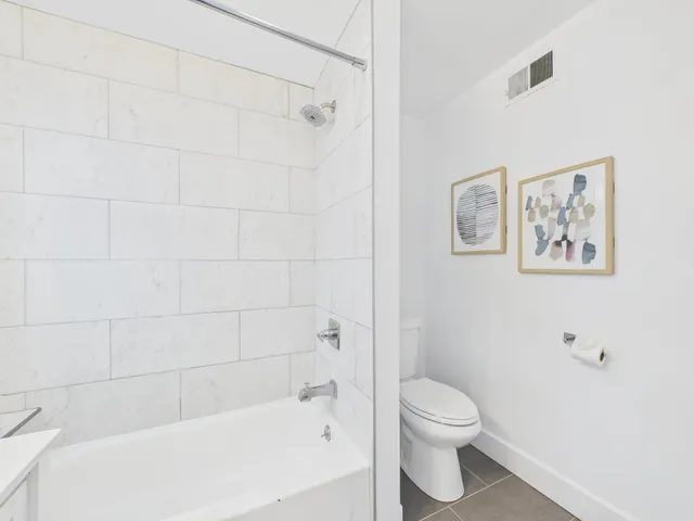 a bedroom with a bed and a couch