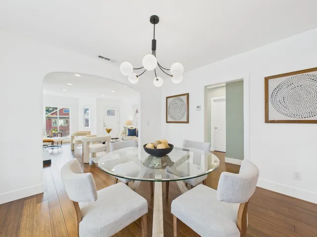 a dining room with furniture and wooden floor