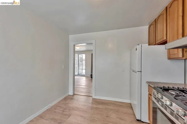 a view of a kitchen with an empty space and a stove top oven