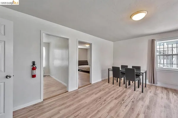 a dining room with furniture and wooden floor