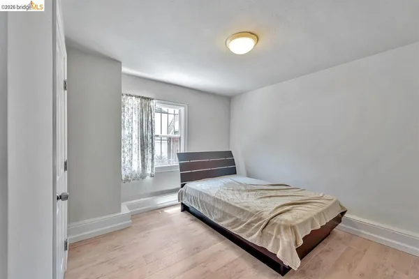 a bedroom with a bed and window