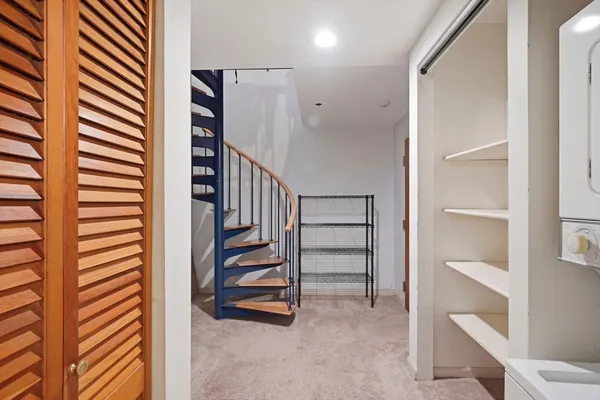 a view of entryway with stairs and white cabinet