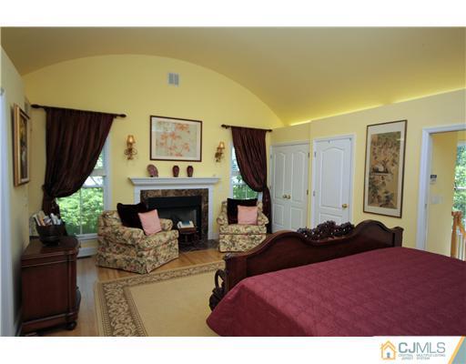 158 Valley Road Princeton, NJ 08540 - Photo 19 of 25 a living room with furniture a fireplace and a flat screen tv