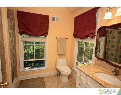 158 Valley Road Princeton, NJ 08540 - Photo 23 of 25 a bathroom with a toilet sink and mirror