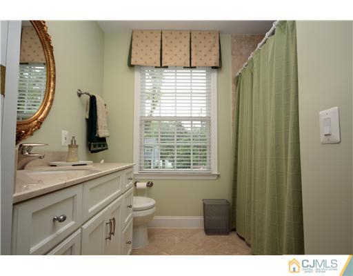 158 Valley Road Princeton, NJ 08540 - Photo 25 of 25 a bathroom with a sink a toilet and a mirror