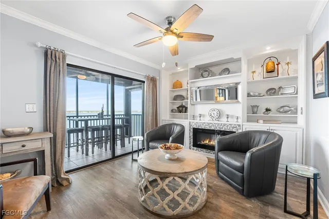 a living room with furniture fireplace and a window