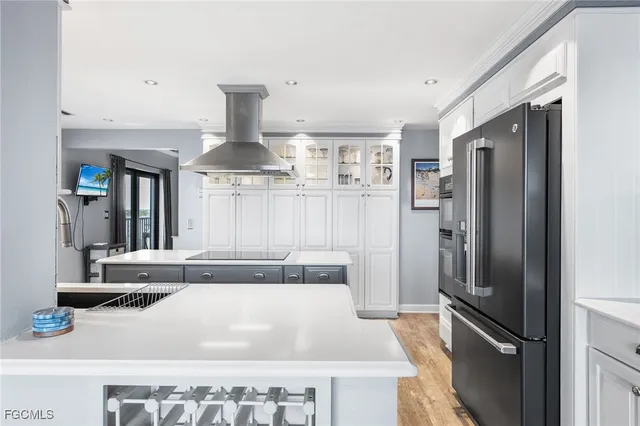 a kitchen with stainless steel appliances granite countertop a refrigerator and a sink