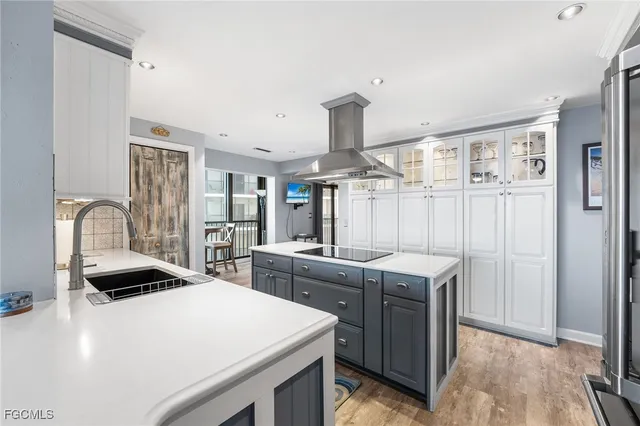 a kitchen with a sink a stove and chairs