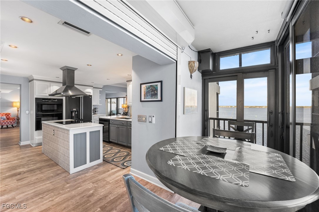 1910 Virginia Avenue, Unit 803 Fort Myers, FL 33901 - Photo 23 of 48 a living room with kitchen island furniture and a kitchen