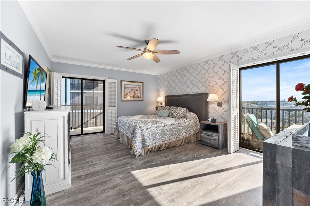 1910 Virginia Avenue, Unit 803 Fort Myers, FL 33901 - Photo 31 of 48 a spacious bedroom with a balcony a bed and a chandelier