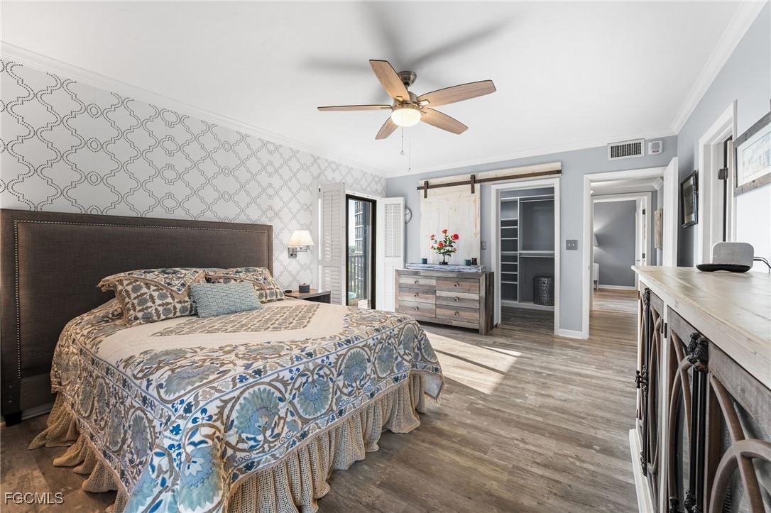 1910 Virginia Avenue, Unit 803 Fort Myers, FL 33901 - Photo 33 of 48 a bedroom with a bed and a chandelier