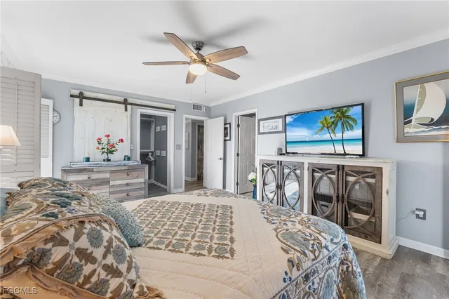 a bedroom with a large bed and a chandelier