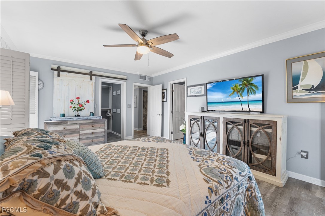 1910 Virginia Avenue, Unit 803 Fort Myers, FL 33901 - Photo 34 of 48 a bedroom with a large bed and a chandelier