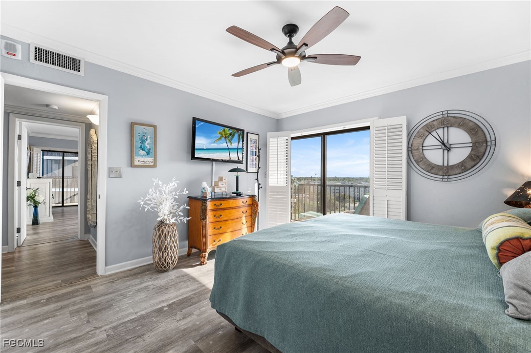 1910 Virginia Avenue, Unit 803 Fort Myers, FL 33901 - Photo 41 of 48 a bedroom with a bed and a chandelier