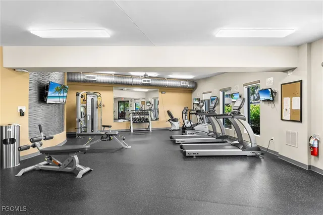 a view of a gym room with gym equipment