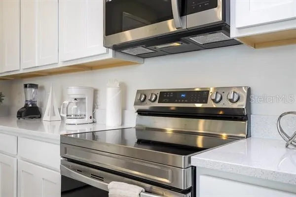 a kitchen with stainless steel appliances a sink a stove and cabinets