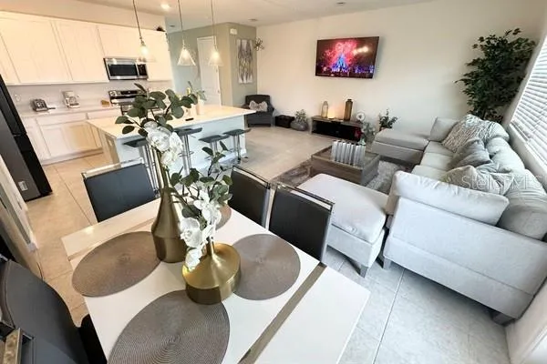 a kitchen with stainless steel appliances a stove a sink a microwave a refrigerator and cabinets