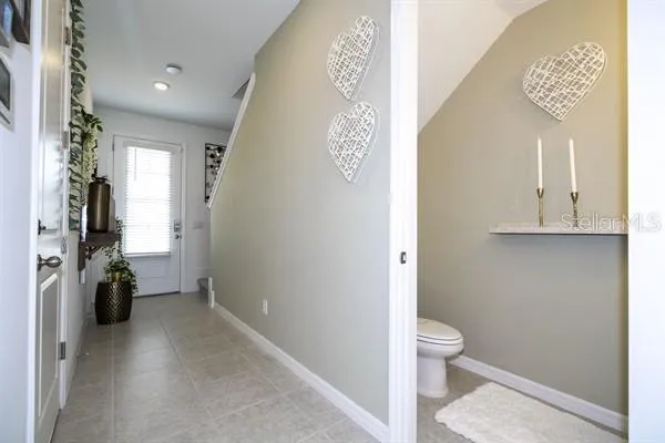 a bedroom with a bed and a flat tv screen on dresser