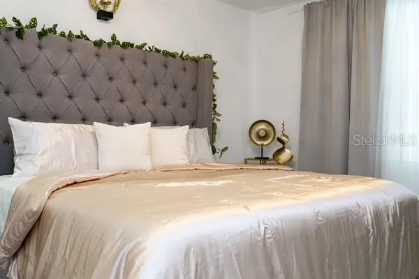 a bedroom with a bed and window
