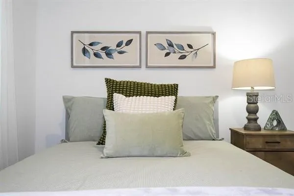 a living room with furniture kitchen view and a large window