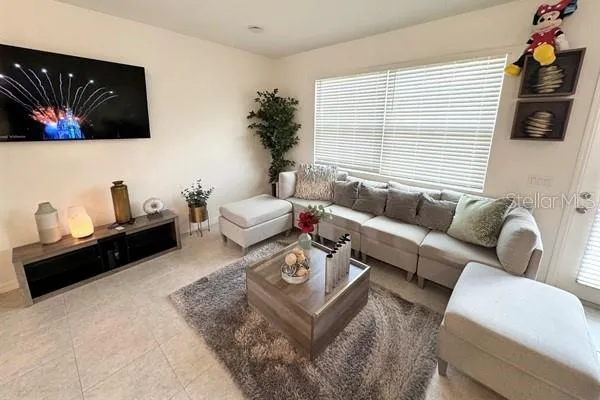a living room with furniture and kitchen view