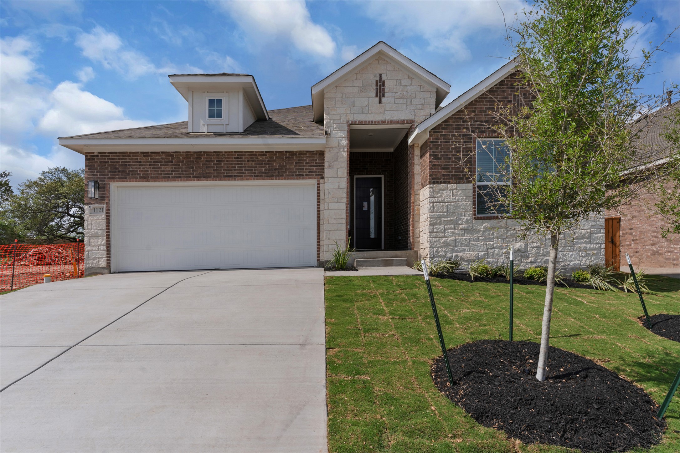 1121 Pansy Trail Georgetown, TX 78628 - Photo 1 of 25 View of front of property with stone siding, a garage, and concrete driveway