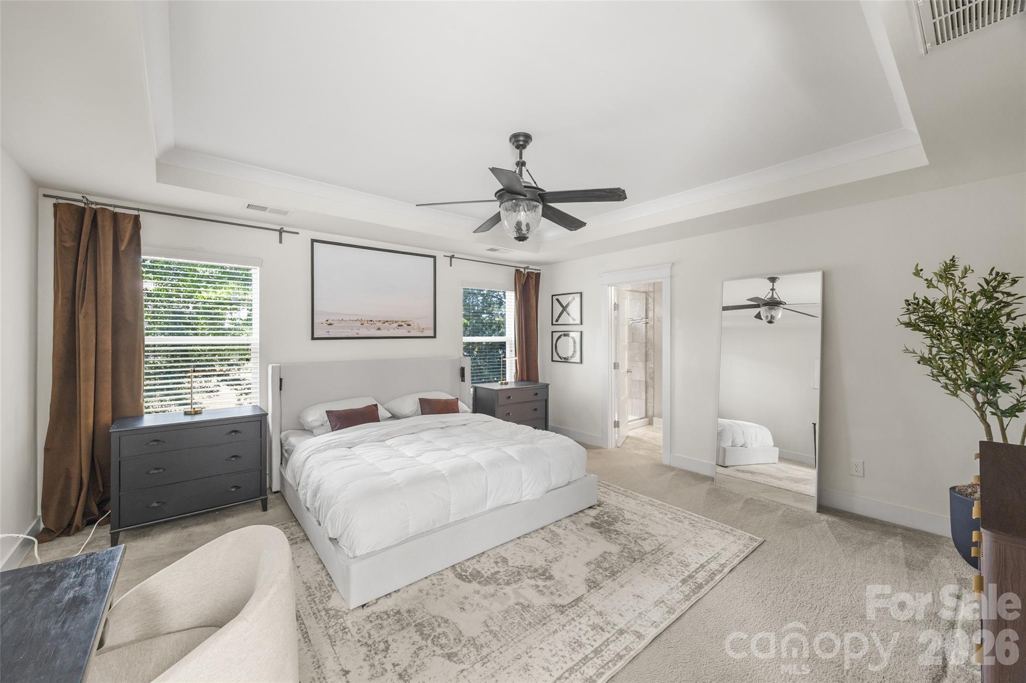 252 Hydrangea Drive Clover, SC 29710 - Photo 23 of 40 a bedroom with a large bed and a chandelier