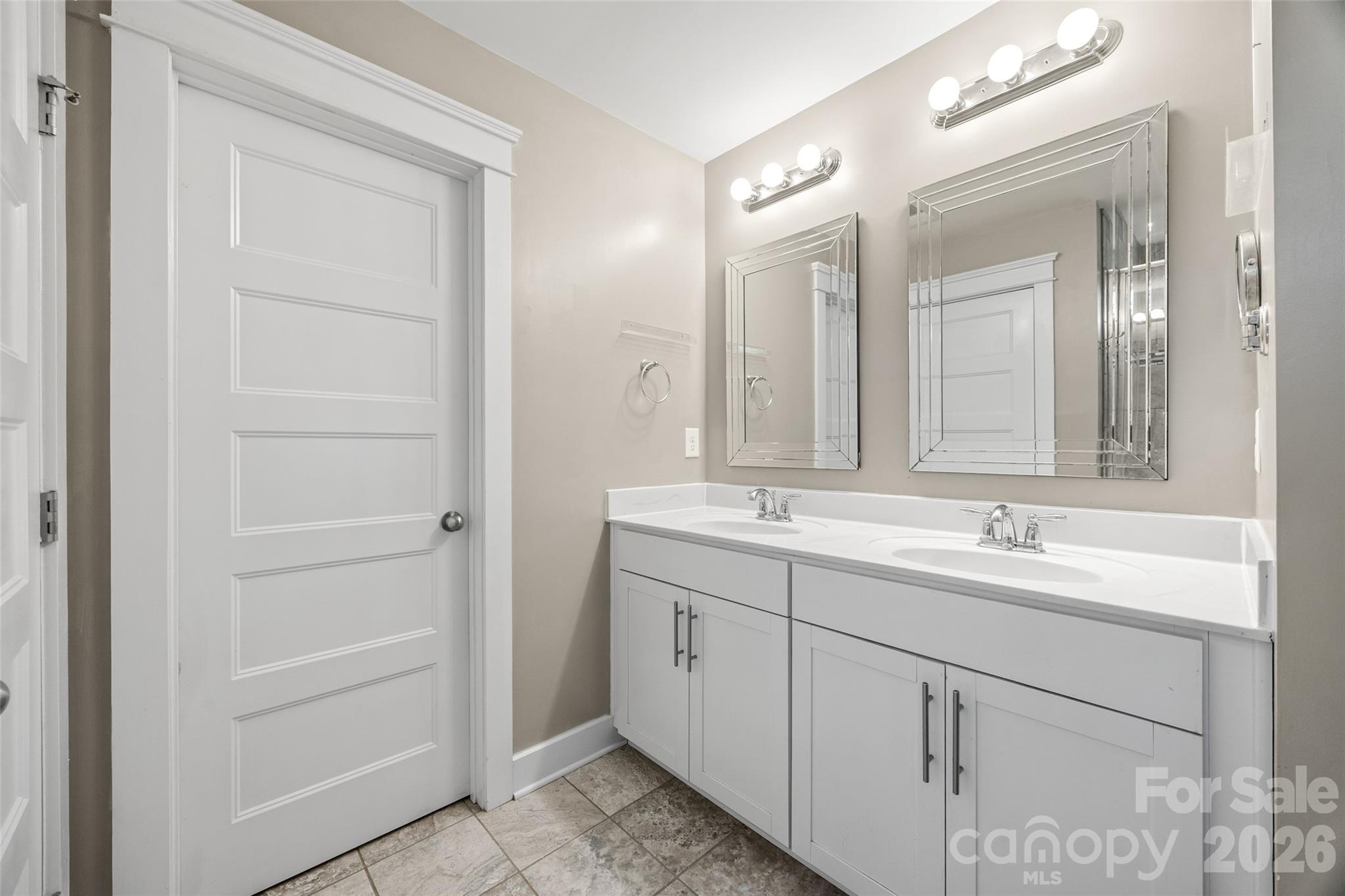 252 Hydrangea Drive Clover, SC 29710 - Photo 25 of 40 a bathroom with a double vanity sink and mirror