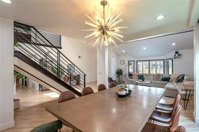 a dining room with furniture and wooden floor
