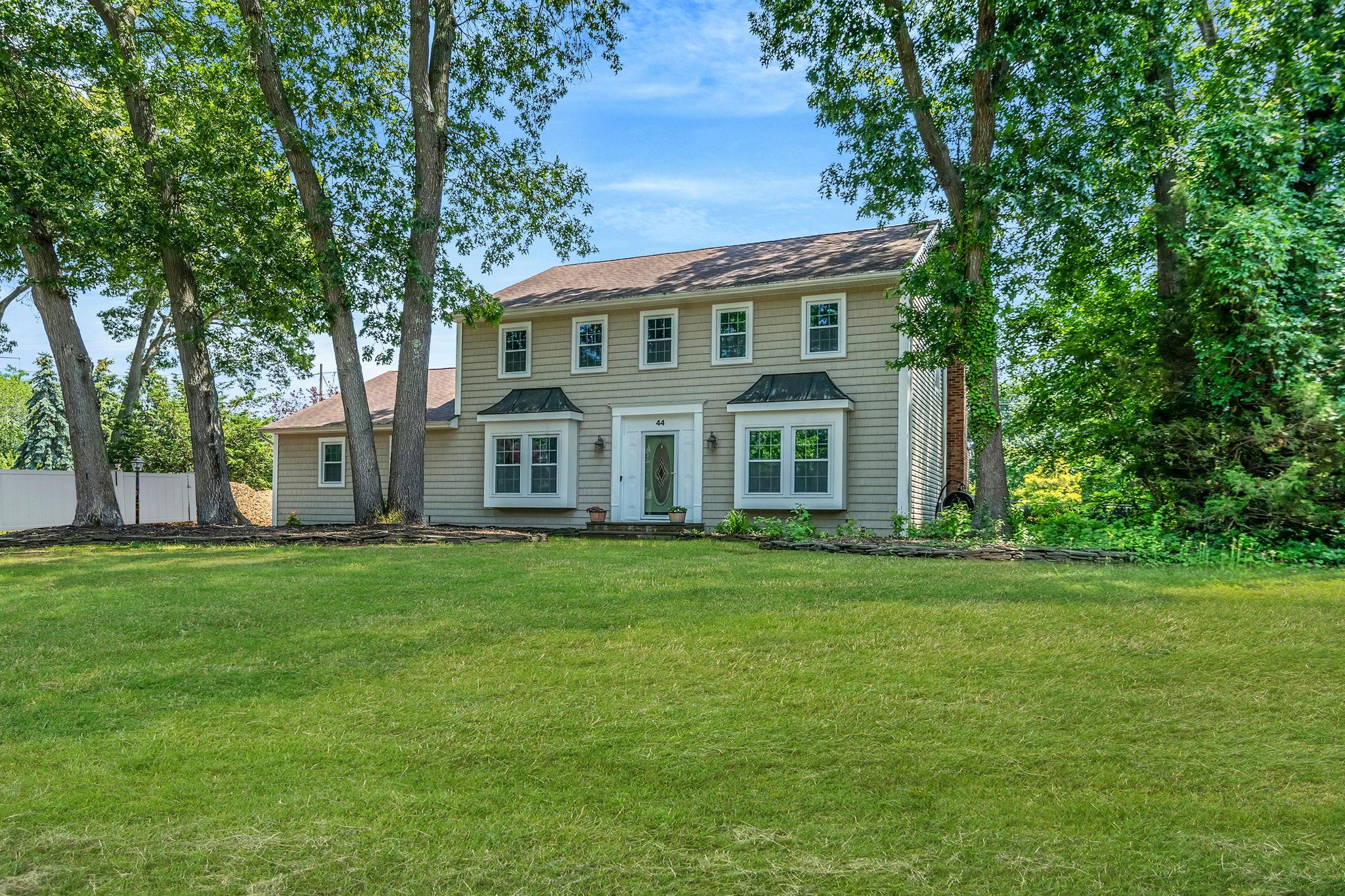 a front view of a house with a garden