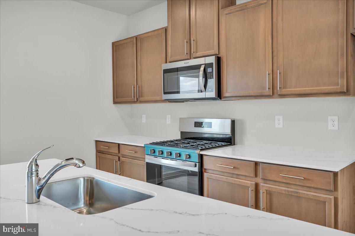 220 Sandy Rdg Road Sicklerville, NJ 08081 - Photo 9 of 24 a kitchen with cabinets stainless steel appliances and a sink