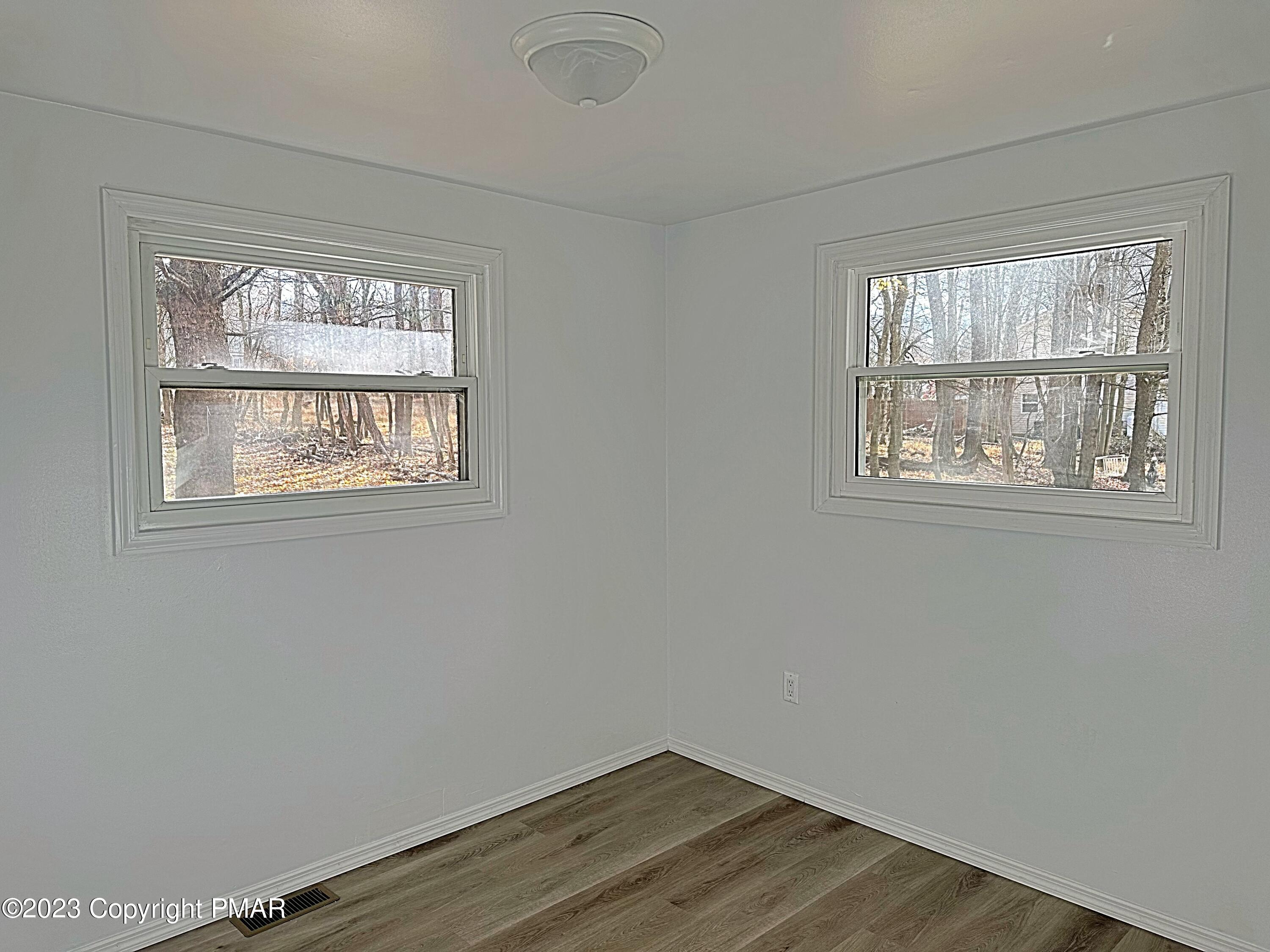 350 Mountain Road Albrightsville, PA 18210 - Photo 13 of 23 a view of an empty room with wooden floor and a window