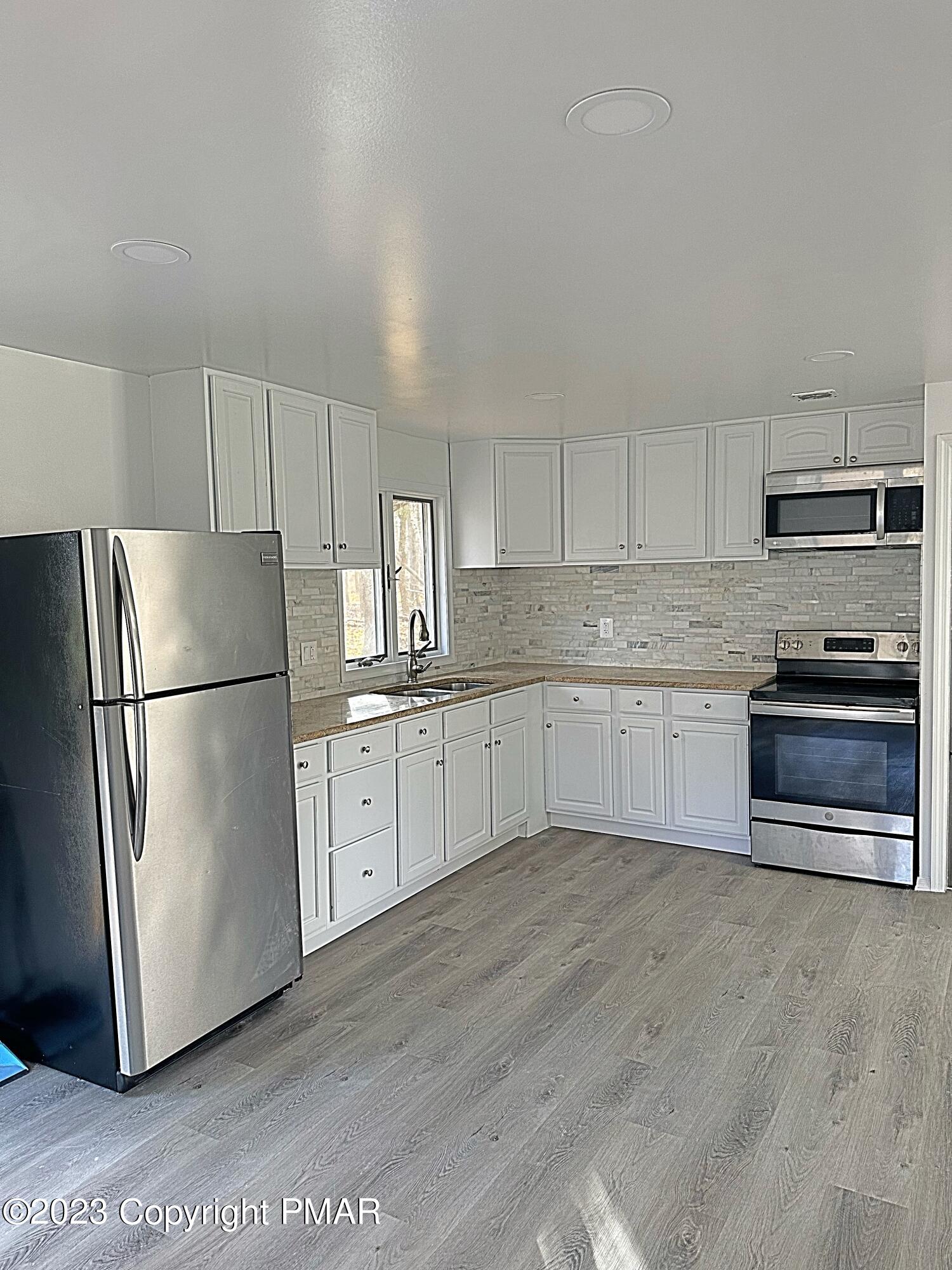 350 Mountain Road Albrightsville, PA 18210 - Photo 15 of 23 a kitchen with stainless steel appliances granite countertop a refrigerator sink and cabinets