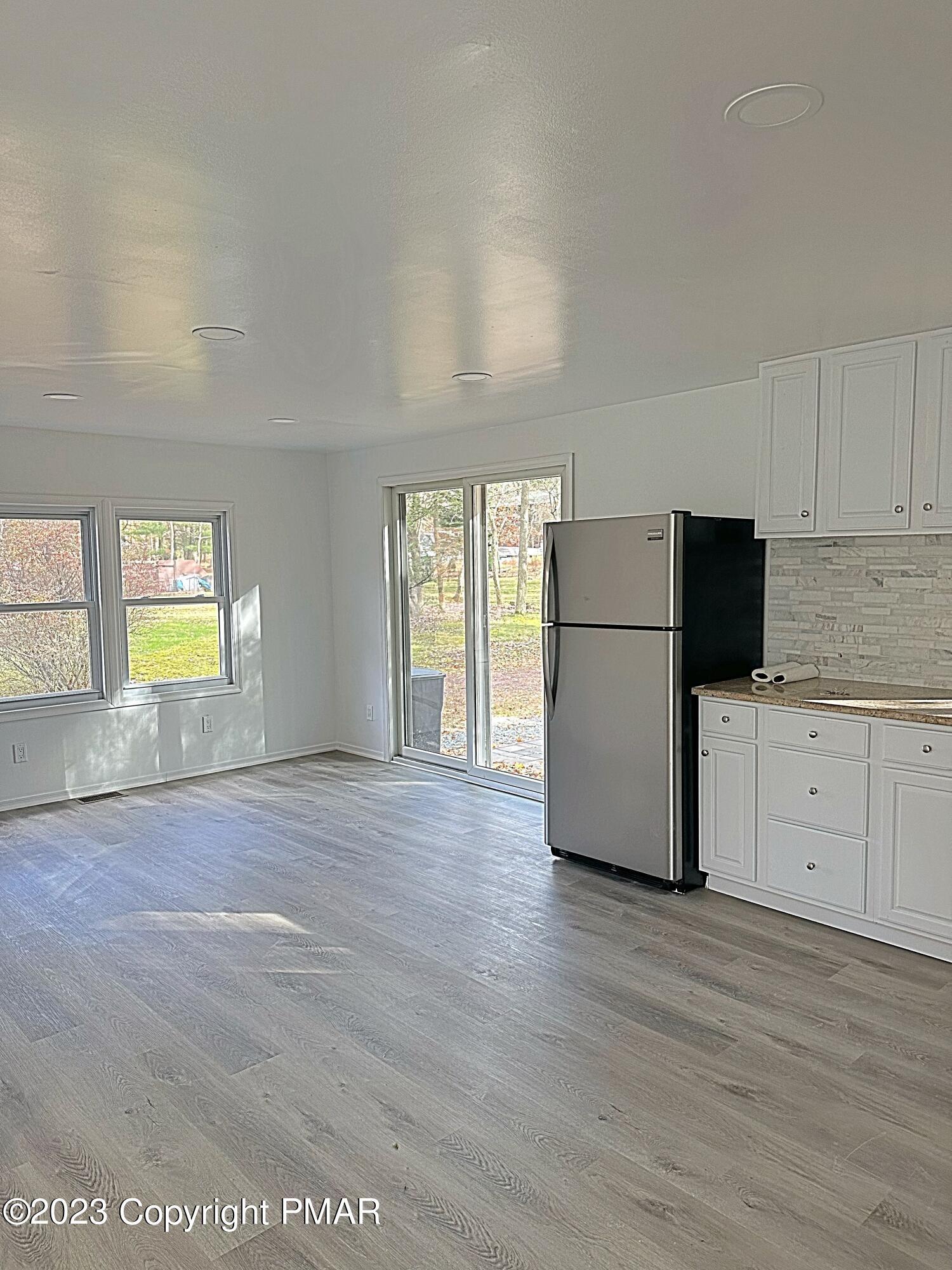 350 Mountain Road Albrightsville, PA 18210 - Photo 3 of 23 an empty room with wooden floor and white walls